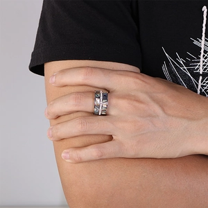 Punk style men's wide stainless steel ring with dark abalone shell inlay on a male model