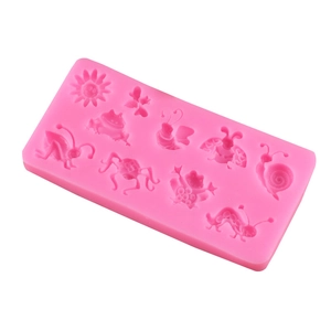 Macro view of pink silicone mold with 3D insect patterns like bees and butterflies