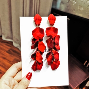 Detailed view of long red layered petal tassel earrings with elegant gold metal links
