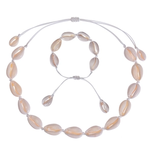 Detailed view of handmade bohemian necklace and bracelet set with natural white shells