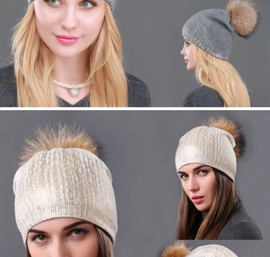 Detail of winter knitted beanie with large fluffy faux fur pompom in grey and champagne