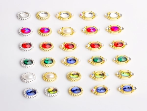 Detailed grid of assorted oval alloy jewelry charms with colorful crystals and pearls
