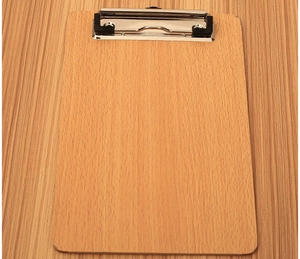 Flat lay of a light wooden clipboard with a silver metal clip on a textured desk