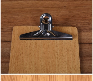 Close-up of the durable silver metal clamp and natural wood grain on the clipboard surface