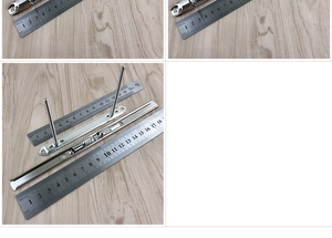 Detailed view of silver metal clipboard hardware with measurement scale for office use