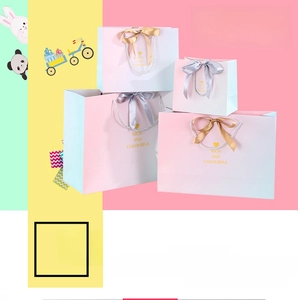 Detail view of four sizes gradient gift bags with silk bow handles and colorful prints