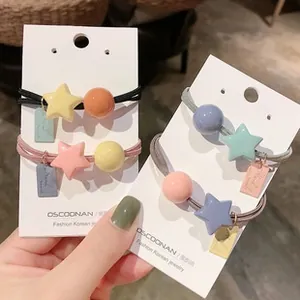 Detail of colorful elastic hair bands with resin star and bead charms in Korean style