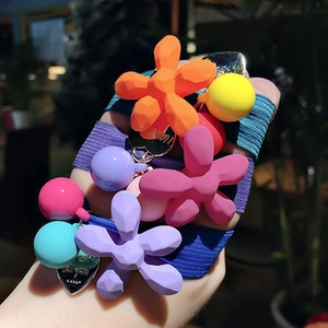 Close-up of vibrant resin flower and colorful bead charms on elastic hair ties