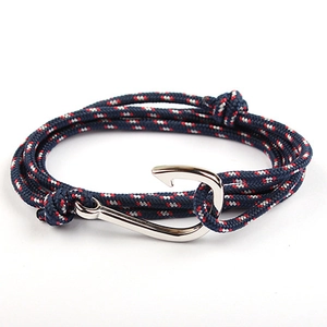 Detail of navy blue braided nautical bracelet with silver fish hook anchor clasp