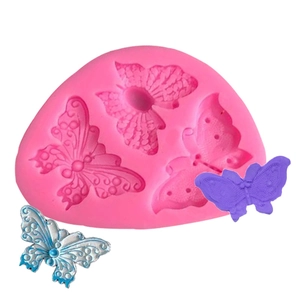 Macro view of a pink silicone mold with 3D butterfly shapes for fondant and wax crafting