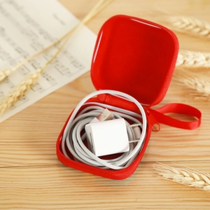 Macro detail of red EVA Christmas pouch showing storage for charger and cables inside