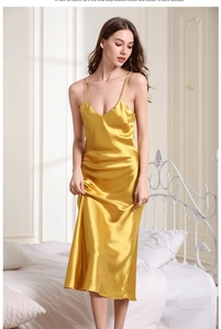 Detail of silk satin nightgown with V-neckline and elegant spaghetti straps in bright yellow