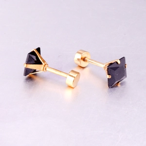 Detailed view of square black crystal earrings with gold four-prong setting and screw backs