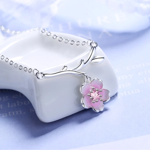 Minimalist silver cherry blossom necklace with pink enamel flower and center gemstone