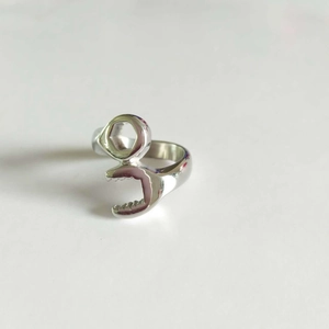 Macro detail of silver biker wrench ring with polished stainless steel finish
