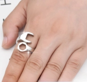 Macro shot of a men's stainless steel wrench shaped biker ring with industrial punk design