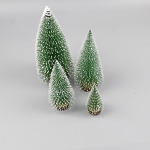 Set of four mini green sisal Christmas trees with snow frost and wooden bases on gray background