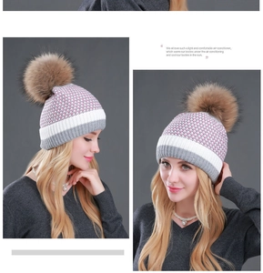 Detail of tricolor knitted beanie with large faux fur pompom in pink white and grey
