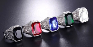 Detailed view of square gemstone rings in black, red, blue, green, and white stones
