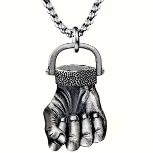 Close-up of fist pendant necklace in vintage silver finish with textured metal detail