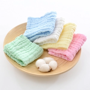 Soft six-layer cotton gauze baby washcloths in macaron colors on a wooden tray