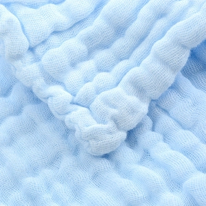 Close-up of light blue six-layer muslin gauze fabric with a soft puckered bubble texture