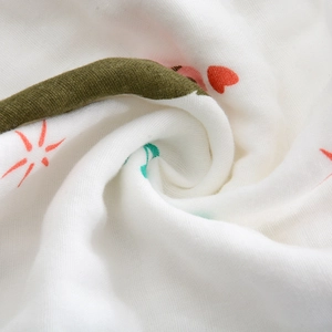 Detailed macro view of soft 6-layer cotton gauze towel with heart and olive patterns