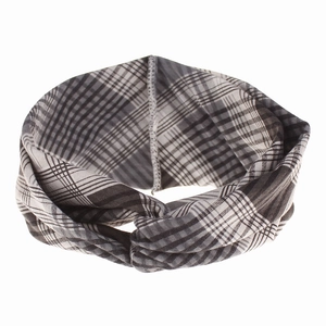 Detail of classic black and white tartan twisted headband with soft fabric texture