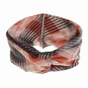Detail of bohemian orange plaid knotted headband with soft knit texture and cross design
