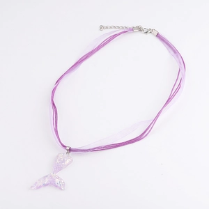 Detail of purple mermaid tail pendant with glitter sequins on multi-strand ribbon cord
