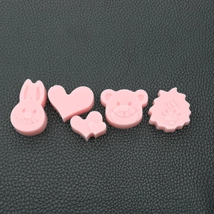 Detail of pink resin animal charms with rabbit and bear shapes for DIY jewelry making