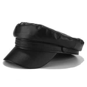 Detail view of the black faux leather texture and stitching on this classic newsboy cap
