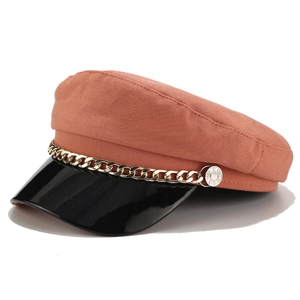 Retro rust red newsboy cap with black patent leather brim and gold chain accent
