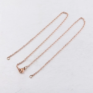 Close-up of a rose gold stainless steel cable chain necklace with lobster clasp detail