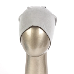 Close-up of lightweight grey knitted beanie on head model showing soft cotton texture