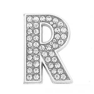 Macro detail of diamond-encrusted silver letter R charm for DIY bracelets and accessories