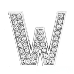 Macro shot of silver chrome letter W charm encrusted with sparkling white rhinestones