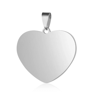 Macro view of polished heart-shaped stainless steel pendant with reflective mirror surface