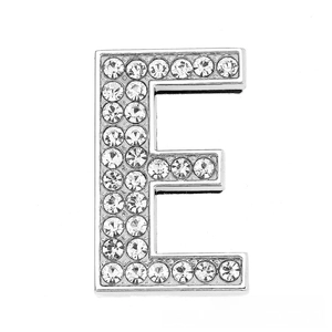 Macro shot of silver letter E slider bead with sparkling white rhinestones for DIY jewelry