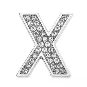 Macro shot of silver letter X charm with sparkling rhinestones for DIY bracelets