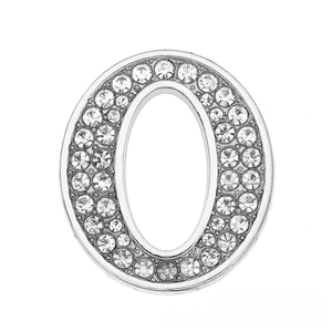 Macro view of 30mm chrome-plated letter O charm with sparkling white rhinestones