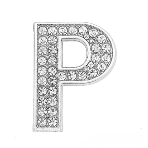 Macro detail of silver-tone letter P slide charm with sparkling crystal pave setting