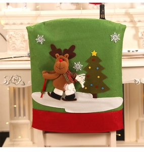 Detail of green Christmas chair cover with 3D reindeer skiing and festive tree design