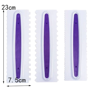 Three white plastic cake scrapers with purple anti-slip grips and serrated edges