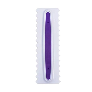 Close-up of a white plastic cake scraper with a purple insert and jagged serrated edges