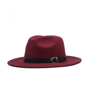 Close-up of wine red wool fedora hat featuring a black leather band and metal buckle