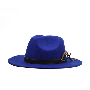 Detail of dark blue wool fedora hat featuring a brown leather decorative band