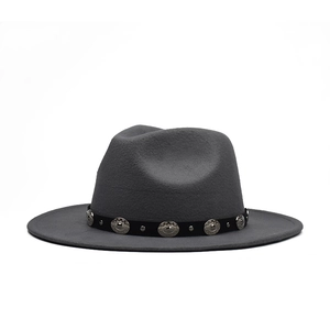 Detailed close-up of charcoal grey fedora with black decorative band and silver metal studs