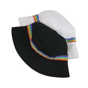 Close-up of black and white bucket hats with vibrant rainbow stripe woven ribbon detail