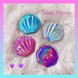 Compact shell-shaped makeup mirrors with iridescent laser finish in four gradient colors